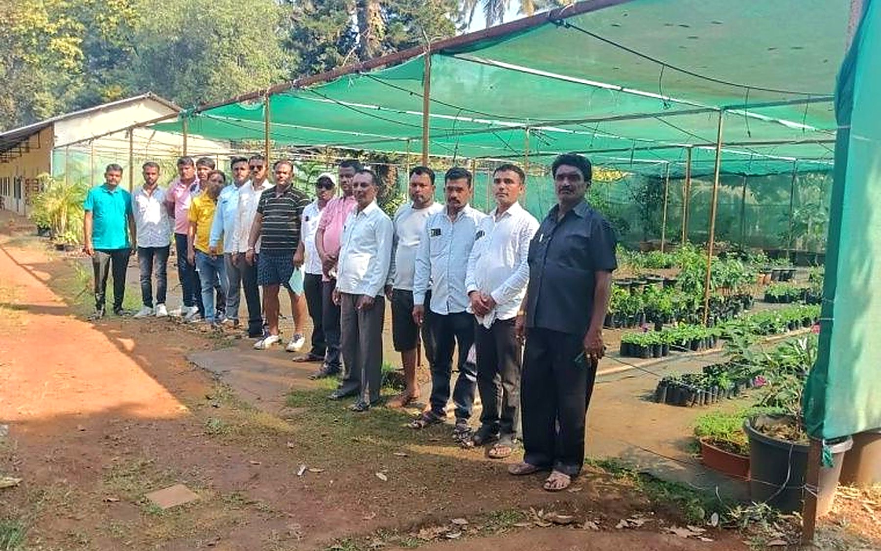 Annapurna team with community members at a plant nursery